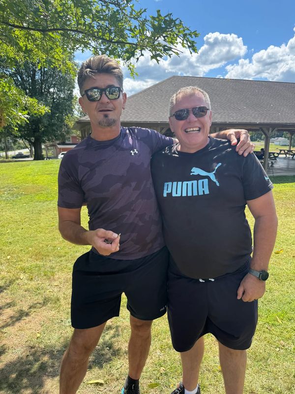 Two friends smiling together at the picnic